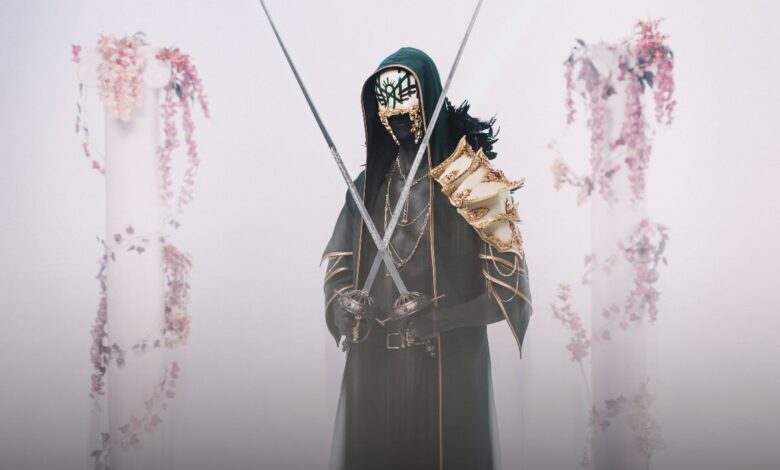 a person in a mask holding swords